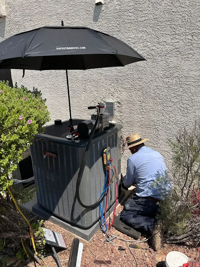 HVAC technician performing outdoor AC maintenance in Broussard